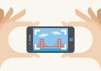 Tourist mobile phone camera taking Golden Gate bridge photo, San Francisco, California. Concepts: photography sharing services (Instagram), tourism, holiday, travel, famous places, vacation, blogging
