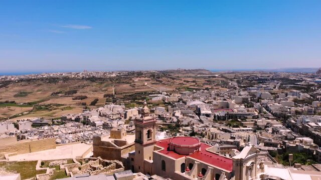 Cittadella historic fortress aerial drone fly backward reveal shot in Gozo, Malta