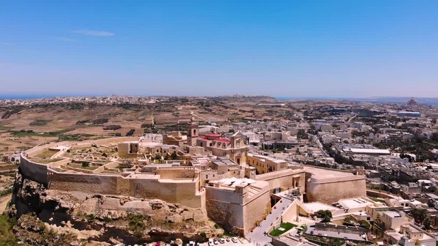 Small medieval fortress name of Cittadella drone pan fly forward to shot. Gozo island panorama, Malta