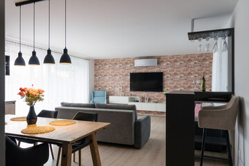 Interior of living room connected to kitchen in modern apartment