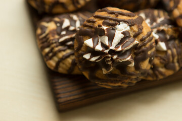 shortbread chocolate unusual striped cookies with marshmallows on a wooden plate tray. Cookies decorated with chocolate.