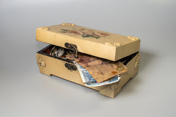 small carved box with old coins