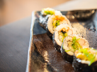 Maki roll served on a sushi plate. Asian or Japanese food.