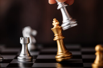 hand holding silver king attack gold leader in game