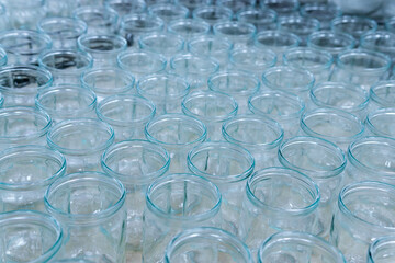 transparent empty glass bottles in a bottling plant, on a production line in a factory or for sale...
