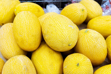 melon on a supermarket shelf. Summer Fruits. Fresh organic melon fruit for sale at the grocery store.