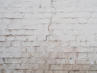 White cracked brick wal background, painted surface texture