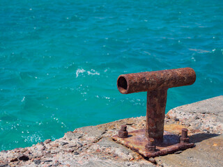 Old iron mooring bollard on the berth