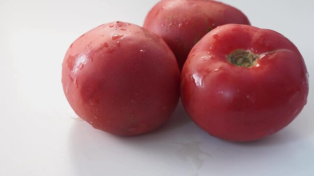 Rose tomatoes close up on white table. Autumn or summer harvest. fresh organic food from garden