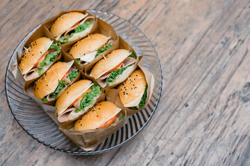 A group of homemade HAMBURGER is wrapped with paper craft and arranged on the dish, ready to serve and eat.