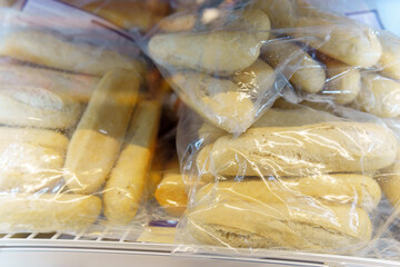 frozen bread in the supermarket refrigerator. ciabatta, loaf, hamburger buns