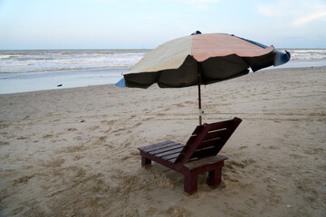 Brown wooden chair at the beach