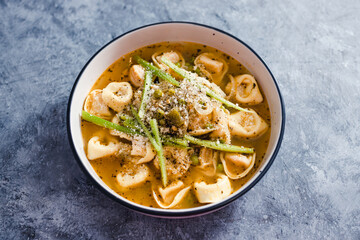 plant-based food,  vegan ravioli pasta with vegetable broth and celeri topping