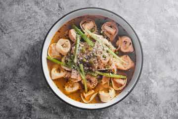 plant-based food,  vegan ravioli pasta with vegetable broth and celeri topping