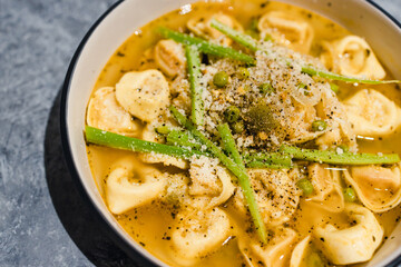 plant-based food,  vegan ravioli pasta with vegetable broth and celeri topping
