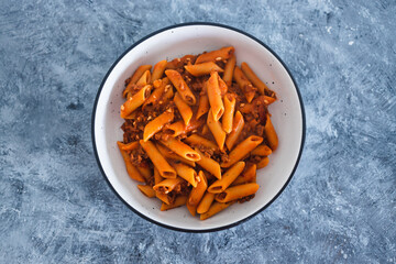 plant-based food, vegan penne pasta with red pesto and bean bolognaise sauce