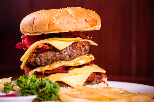 Burger Stack On Plate At Burger Restaurant On A Wooden Background