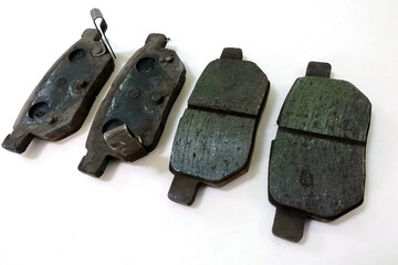 Worn out brake pad or brake shoes, component showing steel backing plates with friction material...