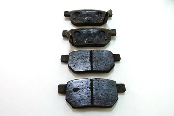 Worn out brake pad or brake shoes, component showing steel backing plates with friction material...