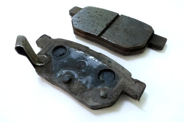 Worn out brake pad or brake shoes, component showing steel backing plates with friction material...