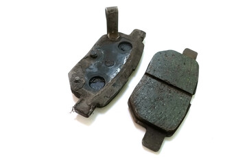 Worn out brake pad or brake shoes, component showing steel backing plates with friction material...
