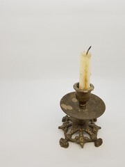 Candle in a candlestick, vintage candle holder on a white background