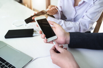 people using power bank charge to mobile phone. Tech Device Charge Sharing Concept.