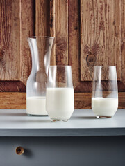 Bottle and two glasses of milk.