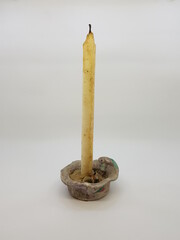 Candle in a candlestick, vintage candle holder on a white background