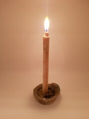 Candle in a candlestick, vintage candle holder on a white background