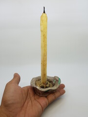 Candle in a candlestick, vintage candle holder on a white background