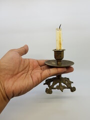 Candle in a candlestick, vintage candle holder on a white background
