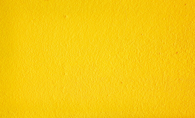 Colorful yellow paint texture on cement wall abstract background