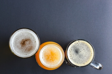 Assortment of beer glasses isolated on black background. Top view. Different kinds of beer