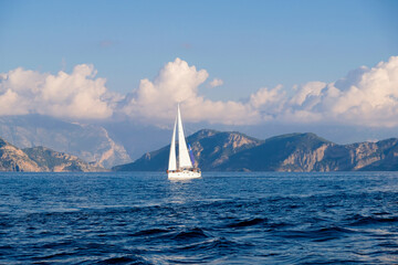 Racing yacht in the sea on blue sky background. Peaceful seascape. Travel concept, travelling.