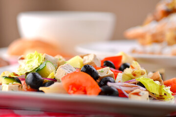 Different food, Italian dishes on the table. Vegetable and meat salad, pasta, soup and puff pastry dessert.