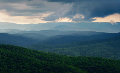 Fototapeta premium Rain over forest mountains. Misty mountain landscape hills at rainy day.