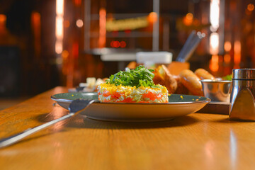 Delicious dinner in restaurant. Served dinner. German Thuringer sausage or bratwurst. Avocado salad with lemon.