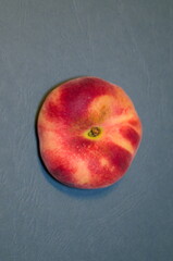 peach top view - exotic fruit nectarine on textured blue-green background