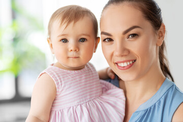 family, child and motherhood concept - portrait of happy smiling mother with little baby daughter...