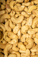 Cashew nuts scattered surface texture. Close up.