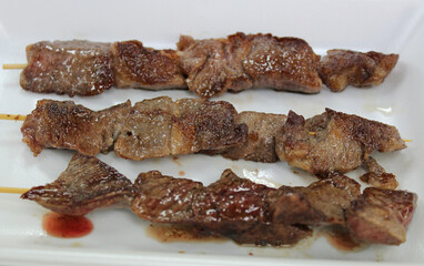 Wagyu and kobe beef sticks in the Kuromon Ichiba Market, Osaka, Japan