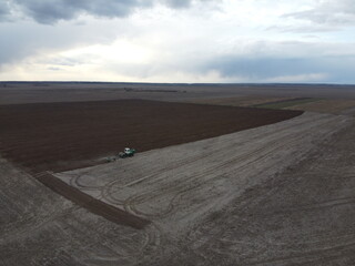 Fototapeta premium Agricultural machinery in the field, aerial view. Agricultural work.