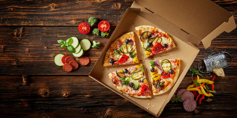 Takeaway Italian pizza in a box with ingredients
