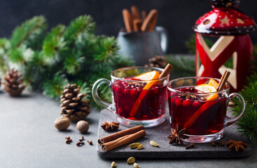 Mulled red wine with spices. Christmas decoration. Grey stone background. Copy space.