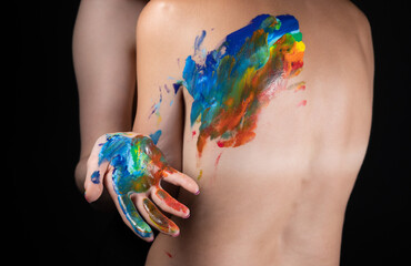 Photo of woman messing up rainbow on nude back