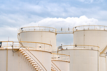 Closeup fuel storage tank in petroleum refinery. White big tank of oil storage. Fuel silo. Liquid petroleum tank. Petroleum oil industrial. Fuel station. Oil refinery plant. Petrochemical industry.