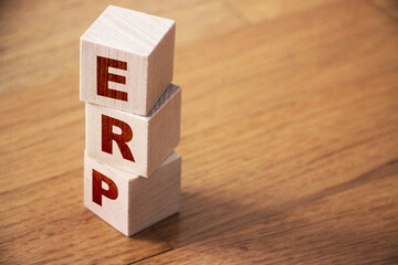 ERP abbreviation made of wooden cubes on wooden table. Business concept