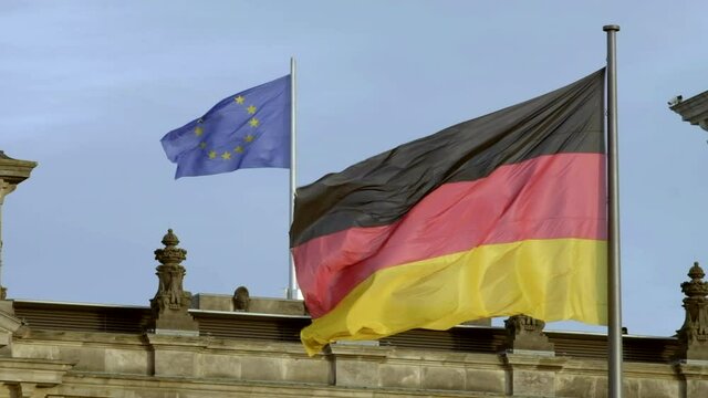 Slow motion of German and EU flags on Reichstag, Berlin 