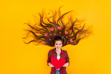 Top view above high angle flat lay flatlay lie concept of nice attractive glad kind affectionate long-haired girl many hearts in hands curls isolated bright vivid shine vibrant yellow color background